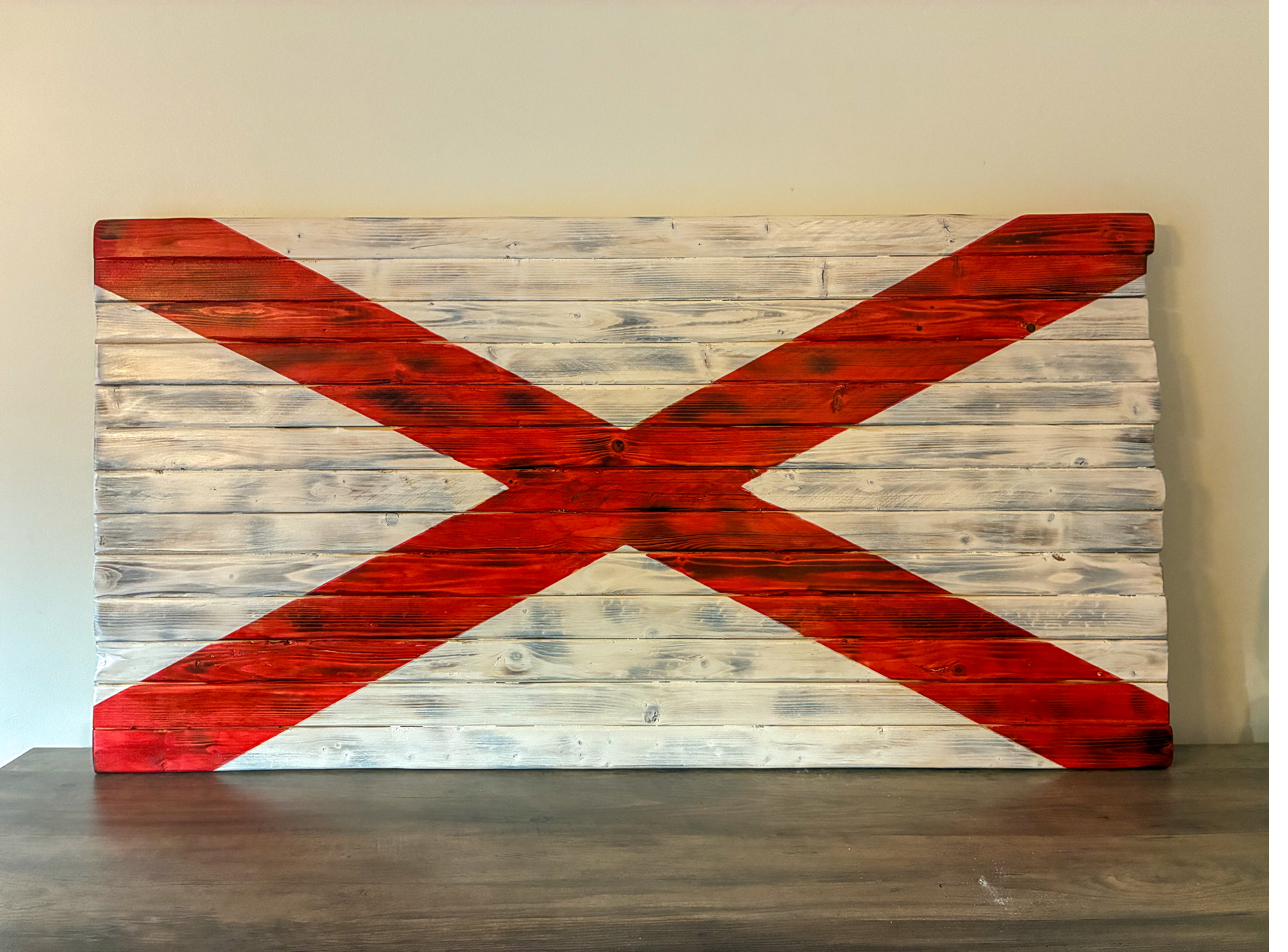Handmade wood Alabama state flag with a bold red cross of Saint Andrew on whitewashed hardwood planks